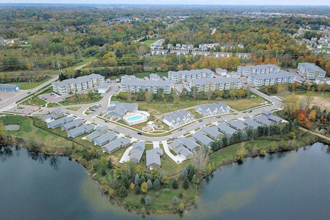 an aerial view of an apartment complex with a body of water
