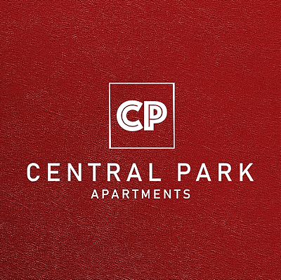 A red poster with the text "Central Park Apartments" and a logo.