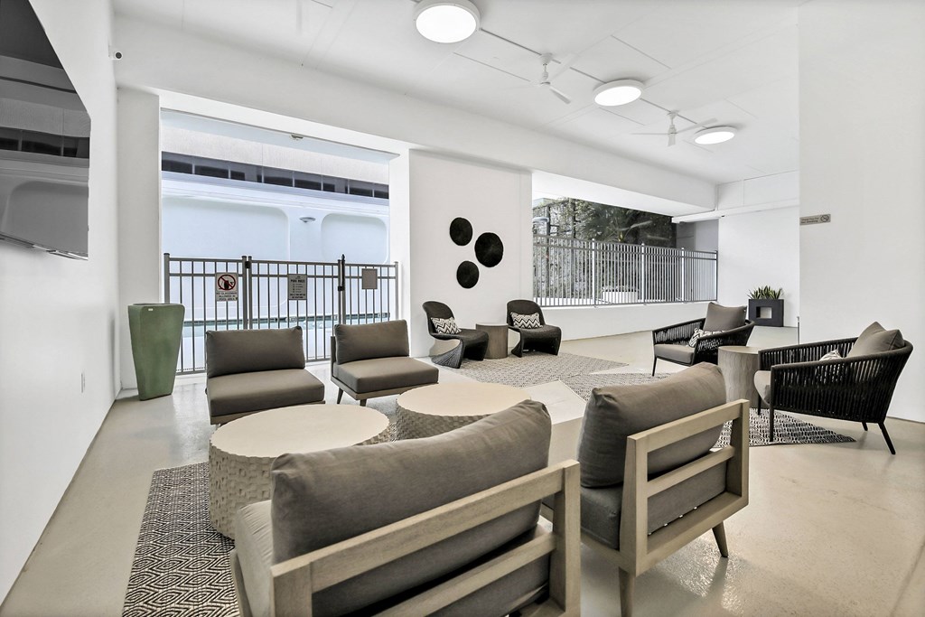 A white room with a couch, chairs, and a table at The Palms on Main, Columbia, 29201