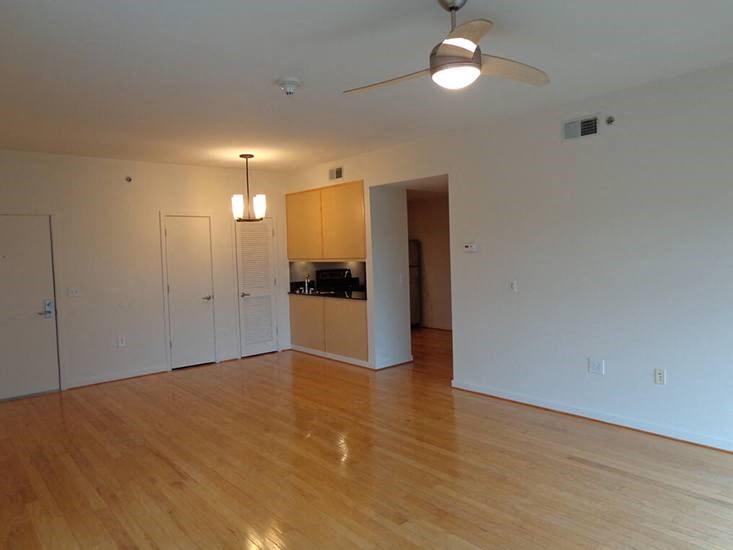 an empty living room with a hard wood floor