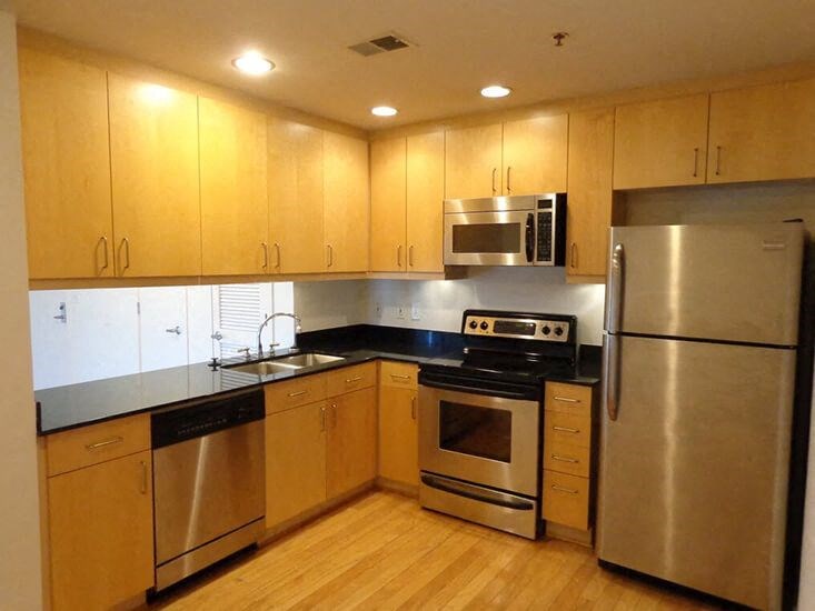 a kitchen with stainless steel appliances and wooden cabinets