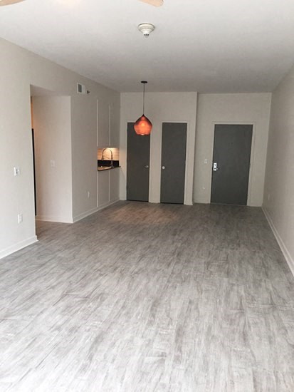 a empty living room with a hard wood floor