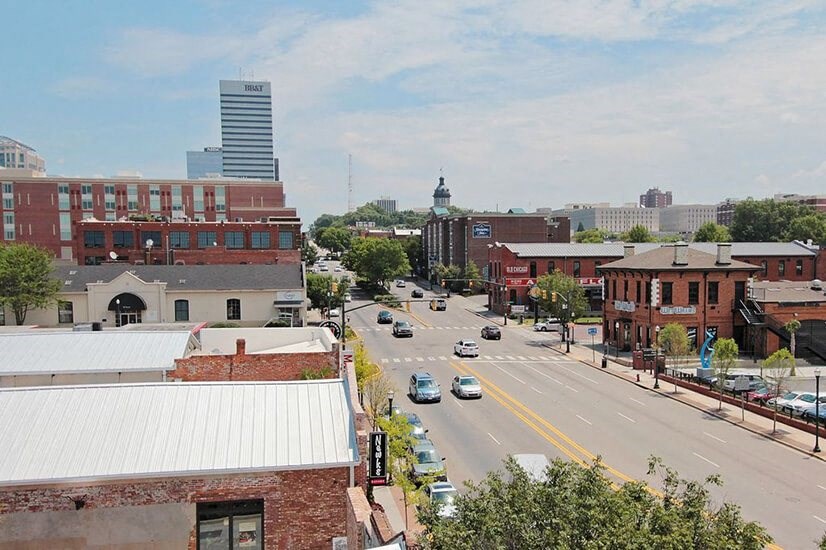 an aerial view of a city street with cars and buildings