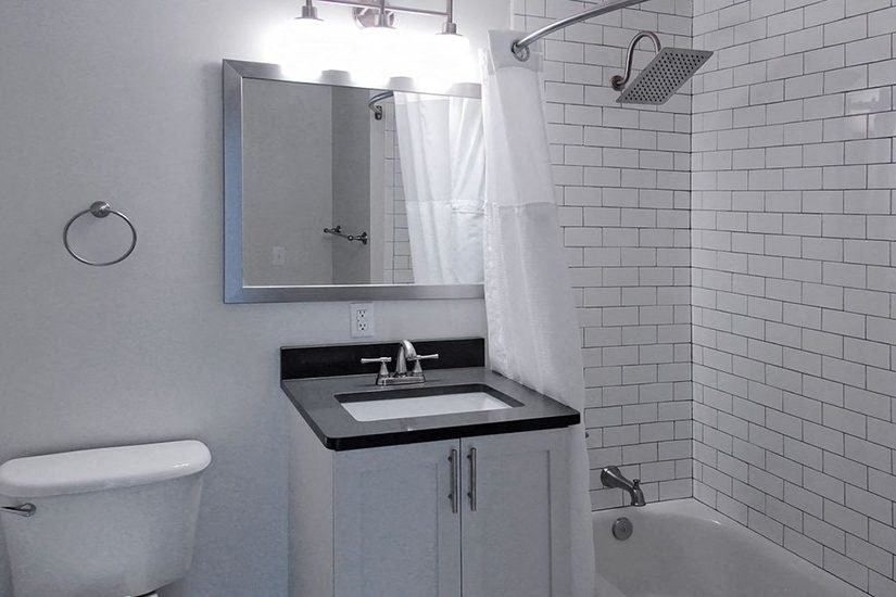 a bathroom with a sink and a toilet and a mirror