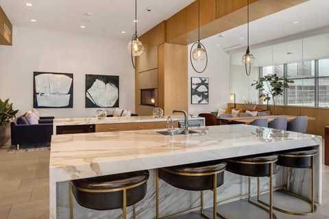 the kitchen has marble counter tops and stainless steel stools the kitchen has marble counter tops and stainless steel stools at Two Lincoln Tower, Bellevue, WA