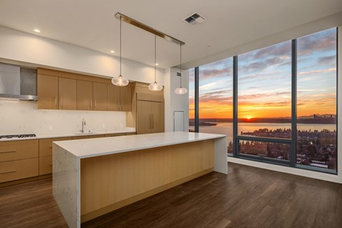 A modern kitchen with wooden cabinets and a large island.