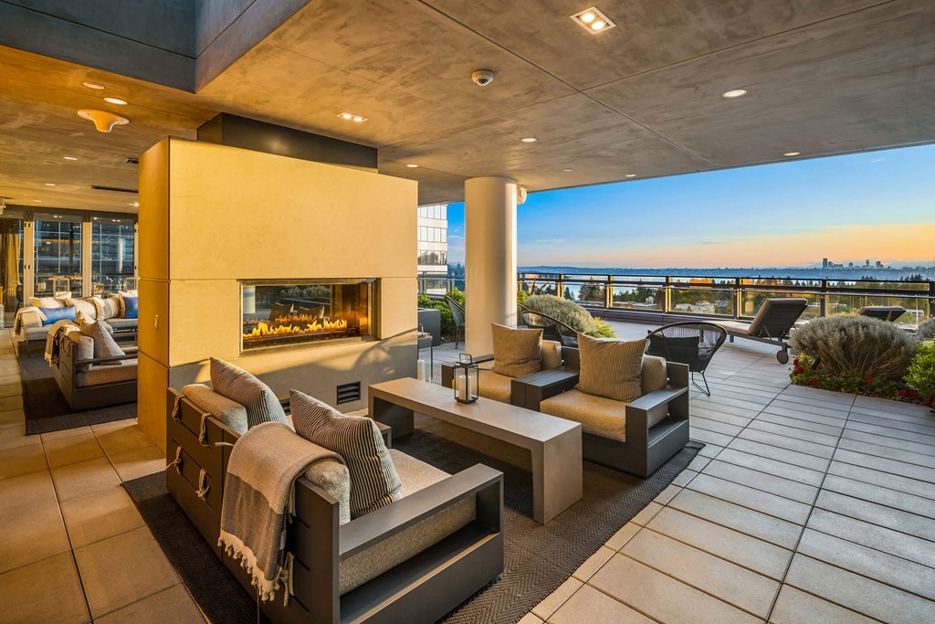 a living room with couches and chairs and a fireplace at Two Lincoln Tower, Bellevue