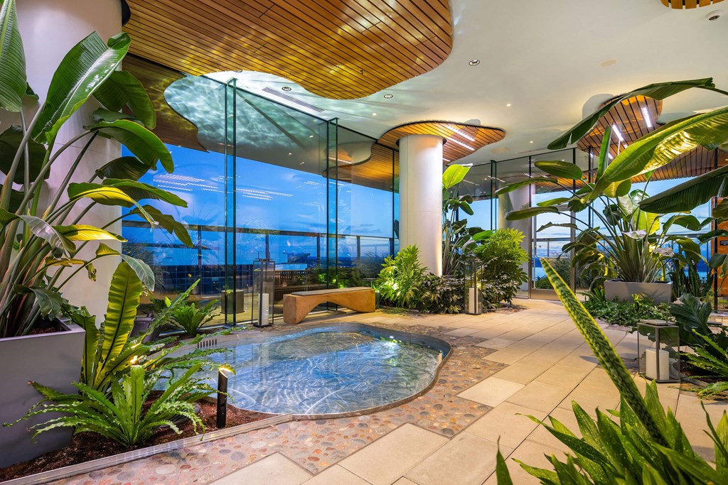 a hotel lobby with a jacuzzi swimming pool and plants at Two Lincoln Tower, Bellevue, WA, 98004