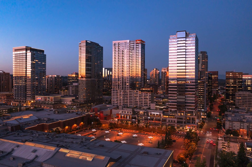a city skyline at night with skyscrapers and a parking lot at Two Lincoln Tower, Bellevue, WA, 98004