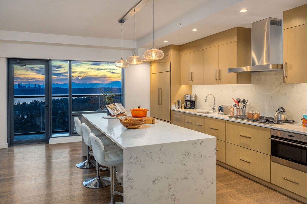 a kitchen with a marble counter top and a large window at Two Lincoln Tower, Bellevue, 98004
