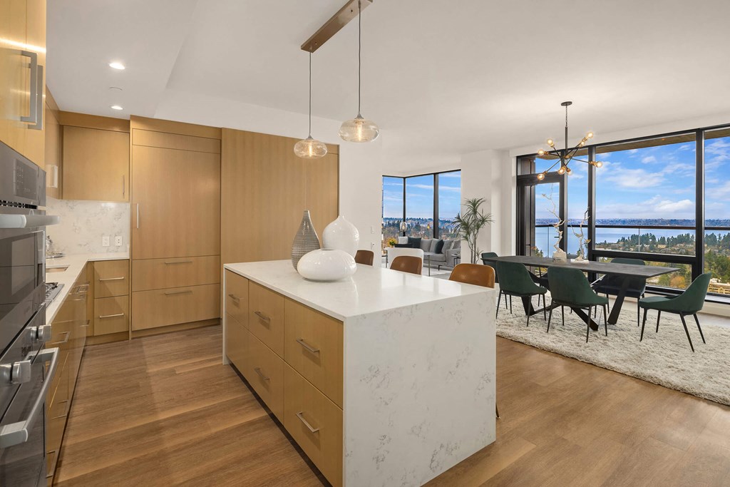 a kitchen with a large island and a table with chairs at Two Lincoln Tower, Bellevue