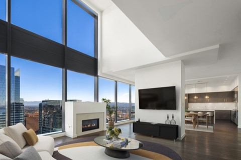 A modern living room with a fireplace and a view of the city.