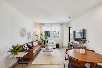 Open Layout Mid Century Modern Furniture Luxury Plan Wood Flooring Oversized Window at The Club at Enclave Apartments in Chula Vista, CA - Photo Gallery 2