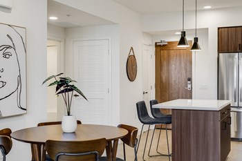 Mid Century Modern Penthouse Decor Dining Room Open Layout to Kitchen at The Club at Enclave Apartments in Chula Vista, CA - Photo Gallery 3