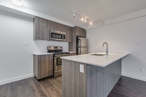 a kitchen with stainless steel appliances and a white counter top