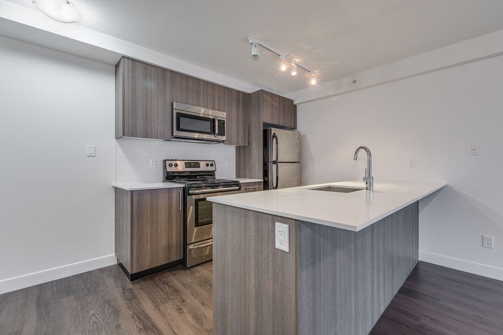 a kitchen with an island and stainless steel appliances