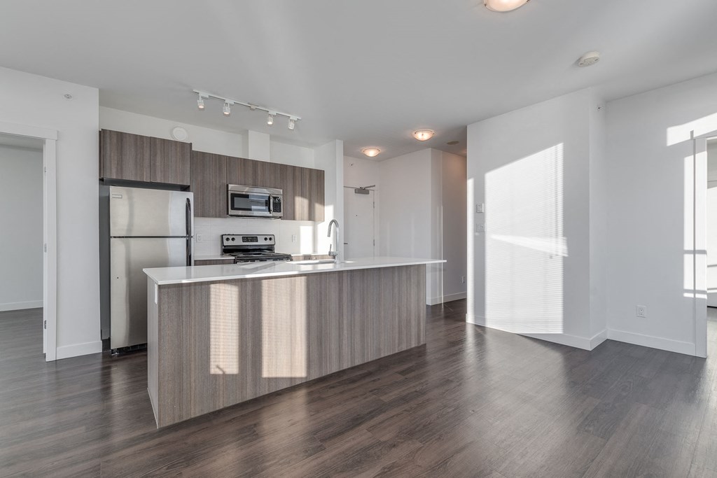 a kitchen with an island and stainless steel appliances