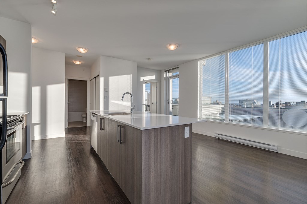 a kitchen with a large island in front of a window