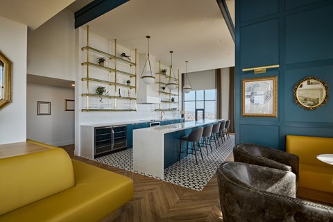 a blue and white kitchen with a blue bar and chairs
