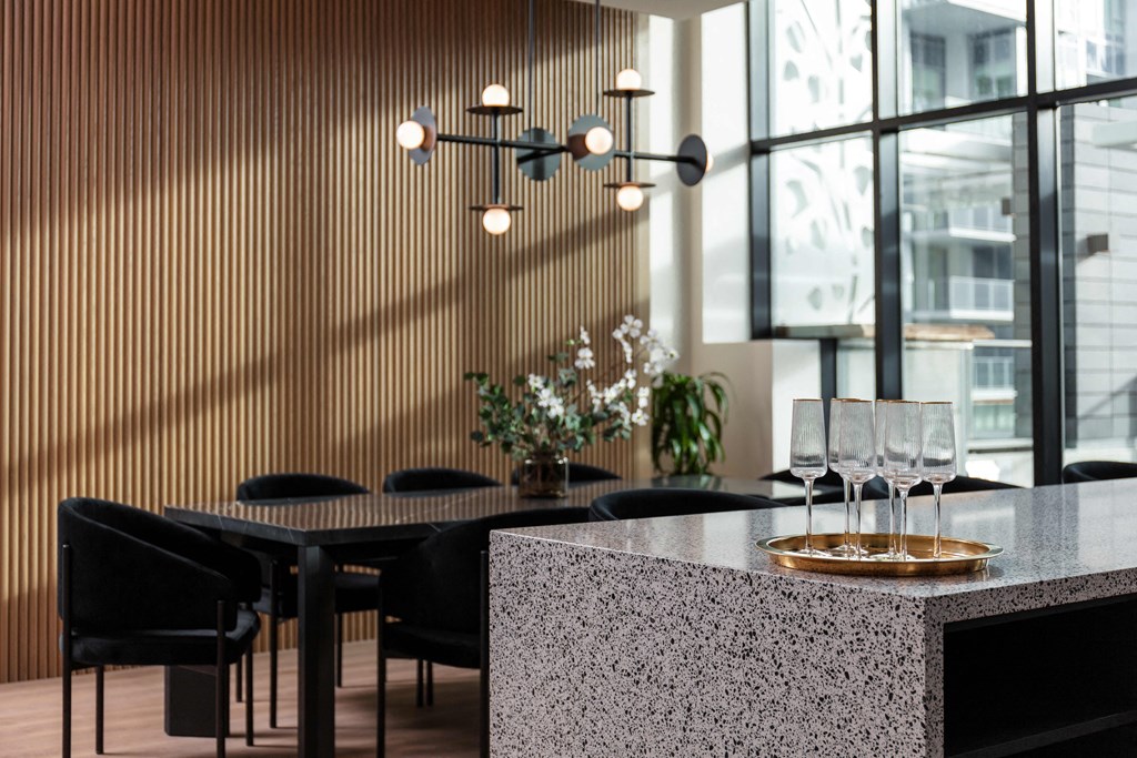 A modern dining area with a table set for two.