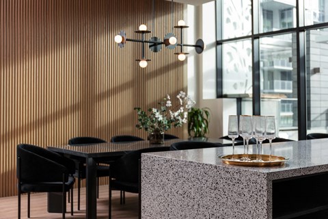 A modern dining area with a table set for two.