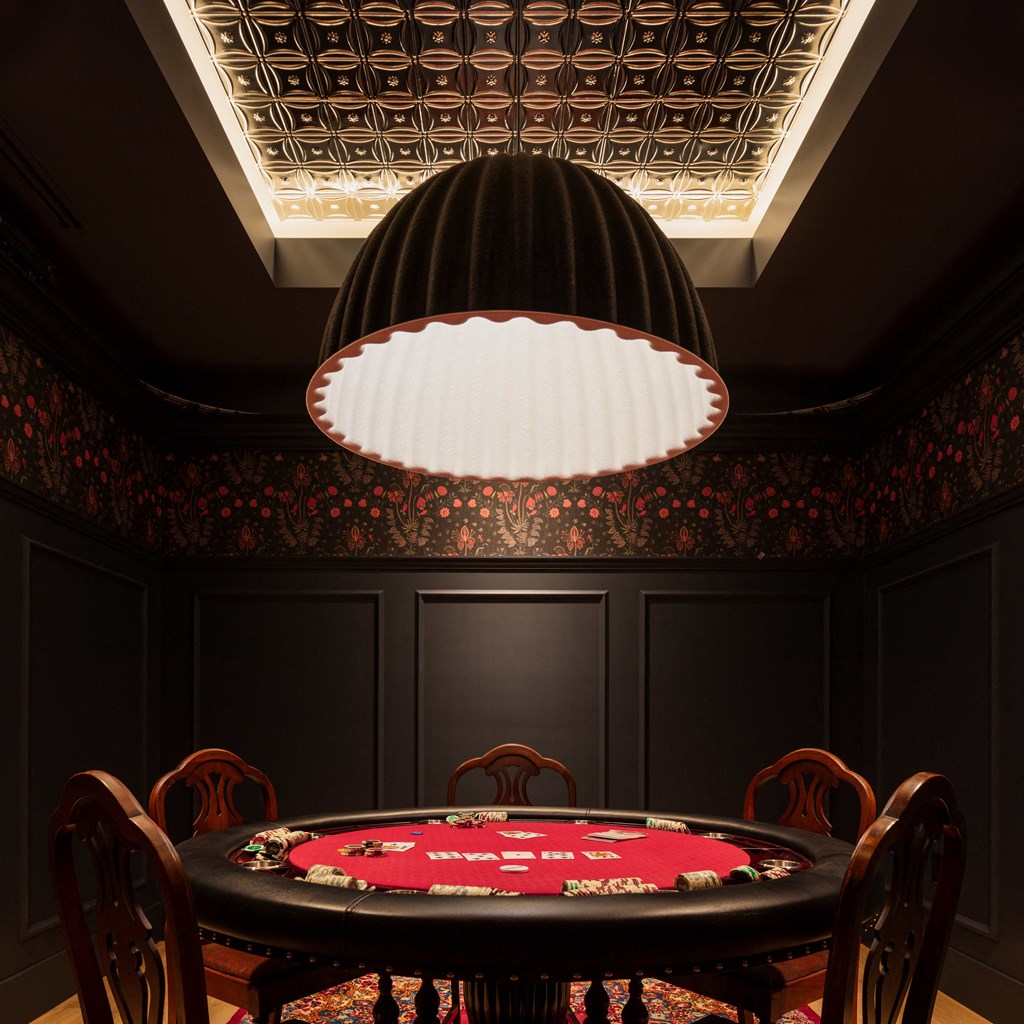 A poker table is surrounded by chairs in a room with a black ceiling.