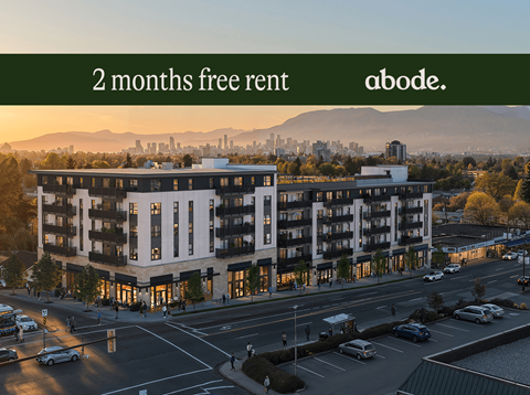 A large building with the text "2 months free rent" and "abode." on it.