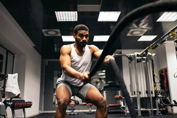 A man is working out in a gym.