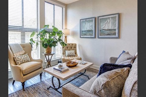 a living room with a couch and chairs and a table