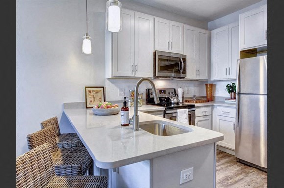 a kitchen with white cabinets and a sink