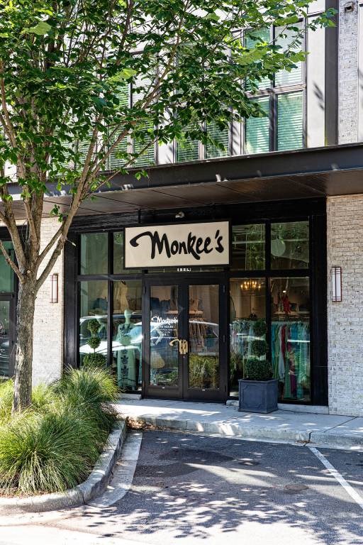 The storefront of Monkee's is visible with a tree in front.