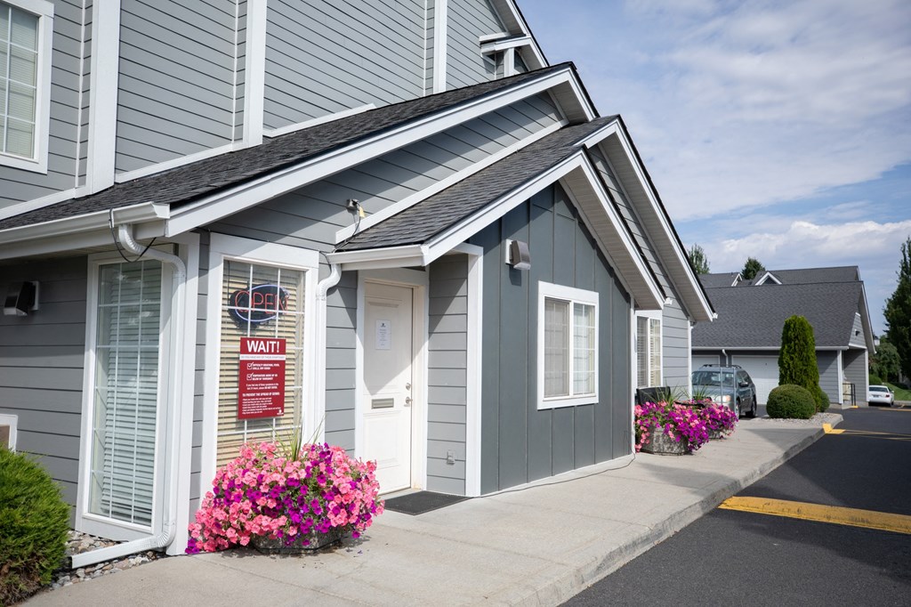 A house with a sign that says at Morning Glory Circle Apartments, Spokane, 99208