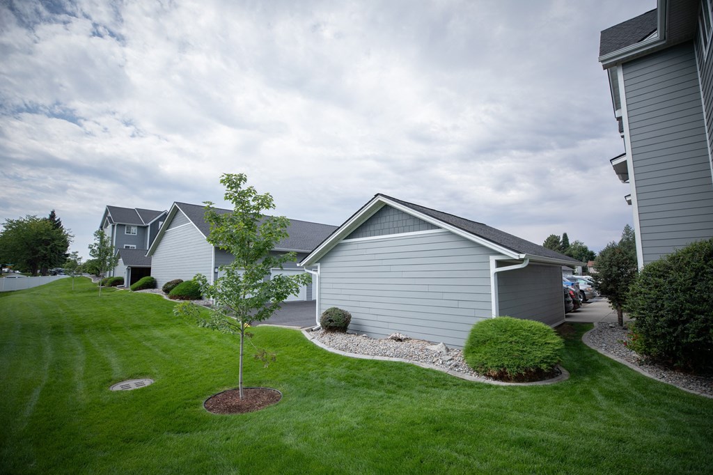 A tree in a small garden in front of at Morning Glory Circle Apartments, Washington
