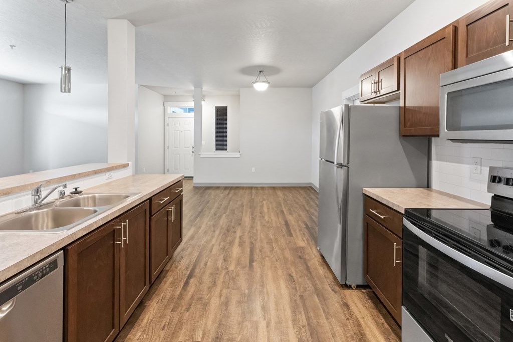 A kitchen with wooden cabinets and stainless steel appliances.