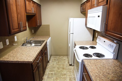 Fully Equipped Kitchen Includes Frost-Free Refrigerator, Electric Range, & Dishwasher at Railhead Apartments, Spokane, Washington