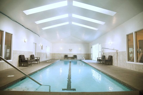 A large indoor swimming pool with a skylight above it at Graymayre Crossing Apartments, Spokane, WA, 99208