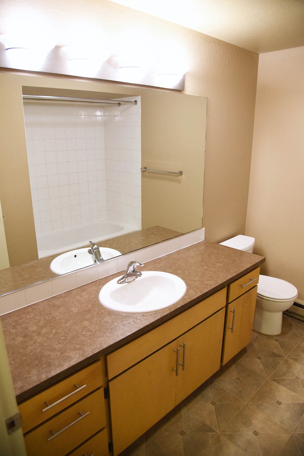 Bathroom with mirror and cupboards at Graymayre Crossing Apartments, Spokane, Washington