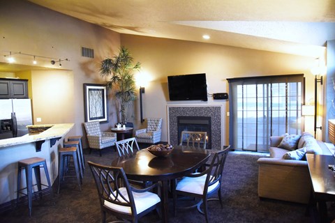 a living room with a fireplace and a dining table