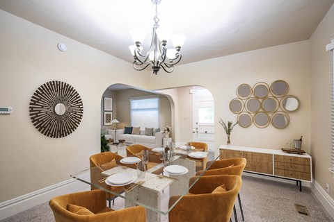 A dining room with a glass table and chairs.
