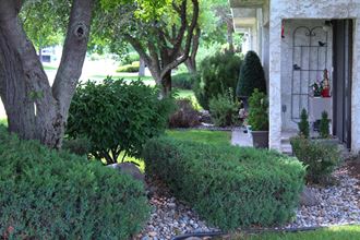 a home with a rock garden in front of the front door