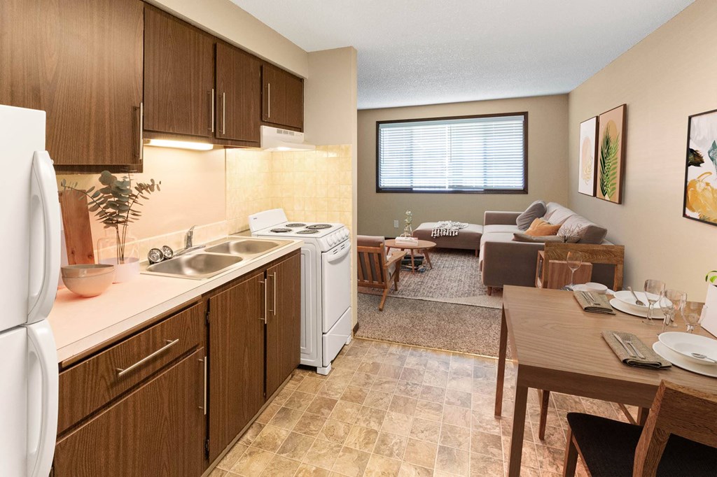 A kitchen with brown cabinets and a white refrigerator.