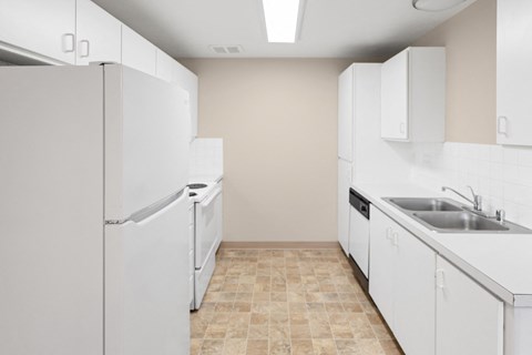A kitchen with white appliances and cabinets.