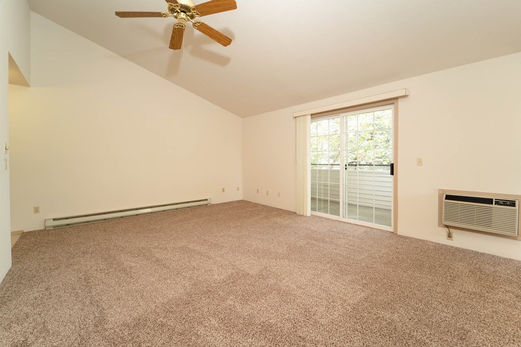 Living room full area with wooden flooring at Morning Glory Circle Apartments, Spokane, Washington