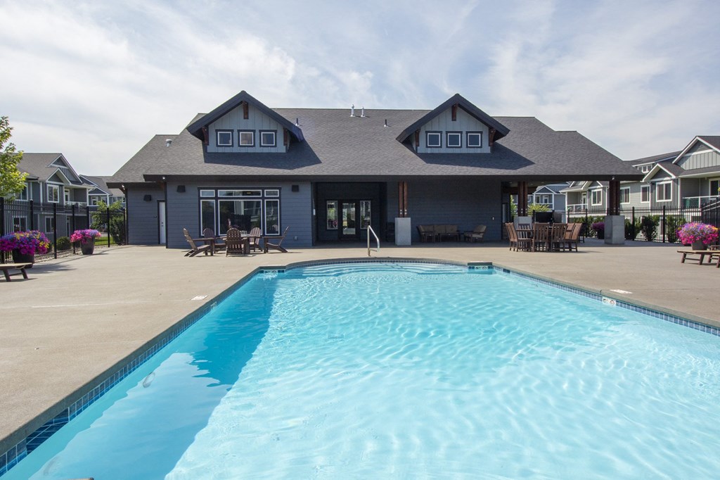a large swimming pool in front of a building