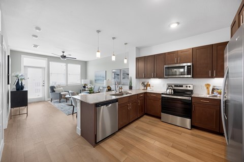 A modern kitchen with wooden cabinets and stainless steel appliances.