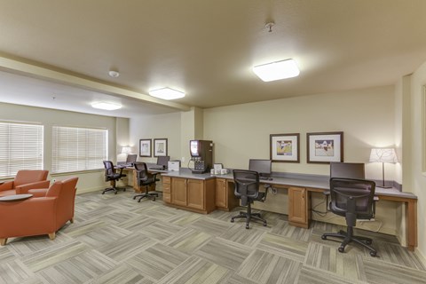 A well-lit office space with multiple desks and chairs.
