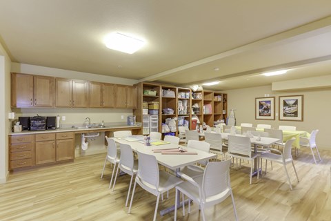 A kitchen with a dining table and chairs.