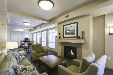 A living room with a fireplace and a painting on the wall.
