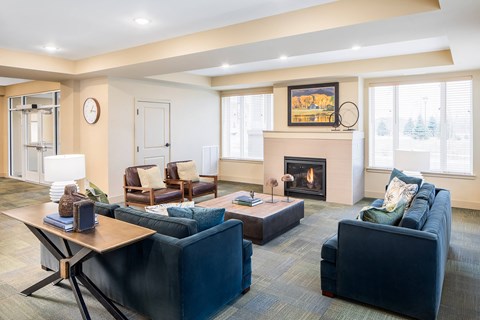 A living room with a fireplace and a painting on the wall.