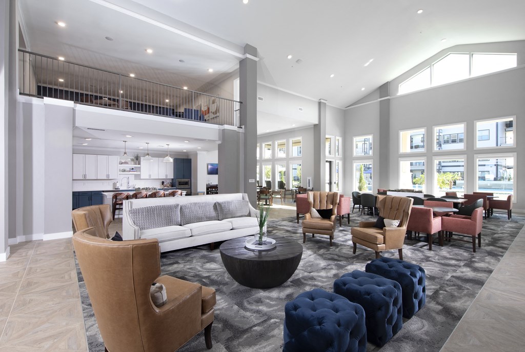 A spacious living room with a variety of seating options and a balcony.